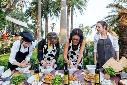 Team preparing a meal during cooking class in Liguria