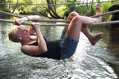 Employee crosses stream during survival training