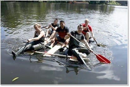 Employee team with the self-built raft on the Alster in Hamburg Employee team with the self-built raft on the Alster in Hamburg