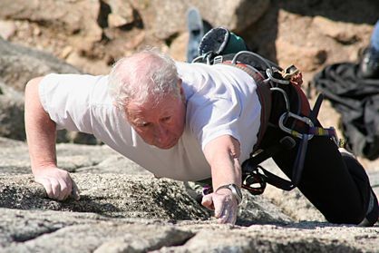 Employee climbing during a survival event Employee climbing during a survival event