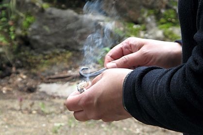 Employees making a fire without technical aids during survival training